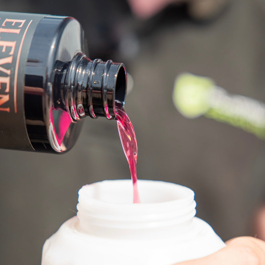 Close-up of a bottle cap being removed from a black E2 bottle with a blurred background