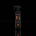 Black spray bottle labeled 'ELEVEN E1 Velora' on a black background