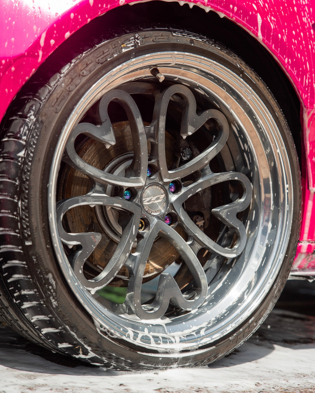 Close-up of a car wheel with a shampoo on 