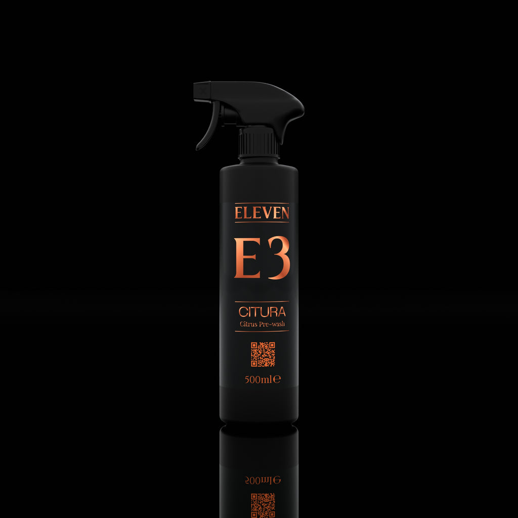 Black spray bottle labeled 'ELEVEN E3' on a black background