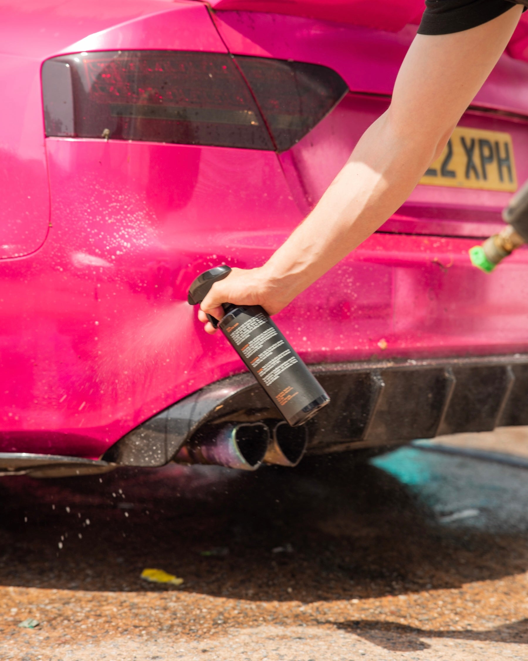 Person cleaning a pink car with a e3 pre wash
