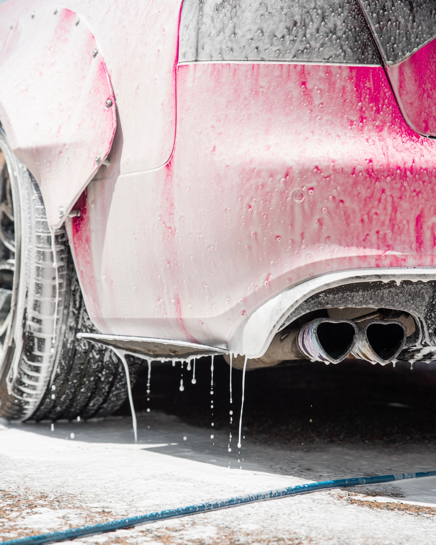 snow foam applied on a pink vehicle